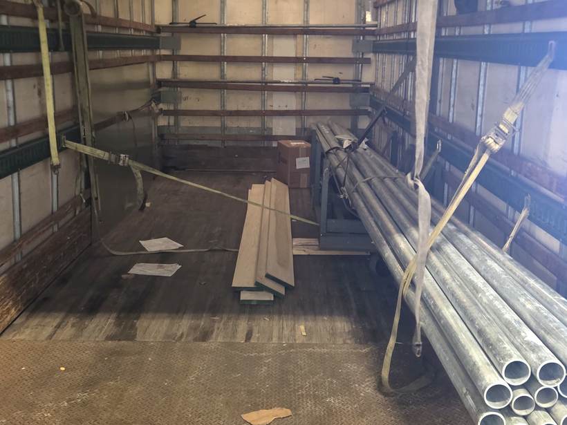 Inside Heavy Hitter's box truck with cargo strapped and secured with e-track ratchet straps