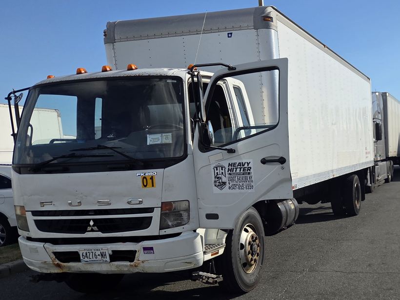 Heavy Hitter Transport white Fuso FK260 box truck, unit 01, with the company door decal, parked at a truck yard